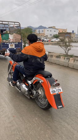 Motorcyclists navigate wet streets in Quetta, Pakistan