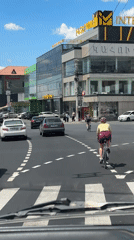 Woman riding observed at busy Yerevan intersection during morning traffic