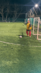 Goalkeeper practices soccer kicks on outdoor field in Bulgaria