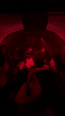 Nightclub scene captured in red-lit Paris venue