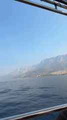 Makarska's coastline from sea and sky, mountains looming behind