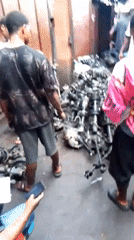 Men inspect car parts at Onitsha automotive market