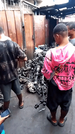 Men inspect car parts at Onitsha automotive market