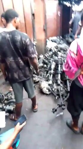 Men inspect car parts at Onitsha automotive market