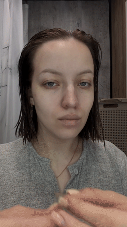 Woman documents morning skincare routine in Russian bathroom