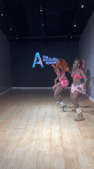 Two women dance in pink outfits at Lekki studio