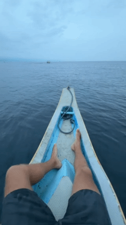 Person resting in wooden boat observed in Buleleng, Indonesia