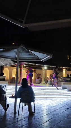 Latin dance performances on a lit outdoor stage in Rhodes