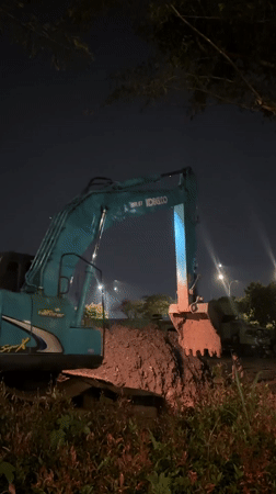 Nighttime excavator operations documented near Tangerang waterfront and hospital