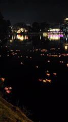 Evening festival features floating lotus displays, flagged bridge, live music