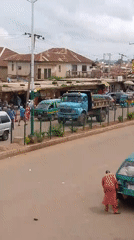 Morning street life along a busy Bukuru, Nigeria commercial strip