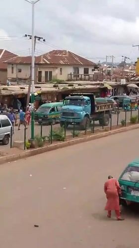 Morning street life along a busy Bukuru, Nigeria commercial strip