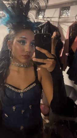 Theatrical performers prepare backstage, perform choreographed show in Porlamar