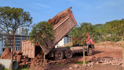Dump truck deposits red dirt in Jiangjin, China