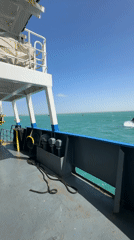 Tugboat passes vessel in calm Colombian waters