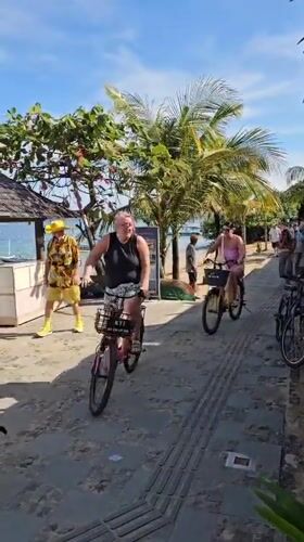 Morning activity captured on beachside walkway in Denpasar
