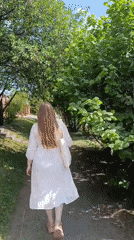 Woman in white dress spends morning at park