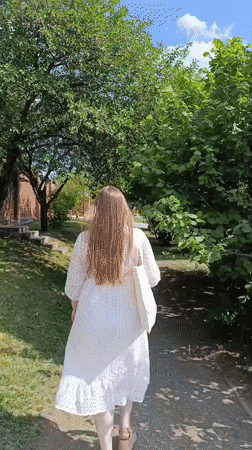 Woman in white dress spends morning at park