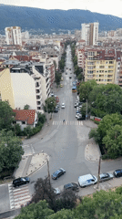 City streets and skyline framed against a mountain range