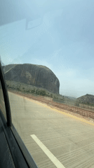 Zuma Rock documented from roadside perspectives in Nigeria