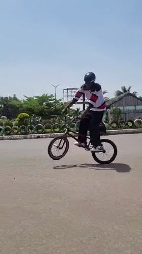 BMX riders throwing tricks on a Jos street