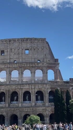 Tourists gather at Rome's Colosseum on sunny May morning