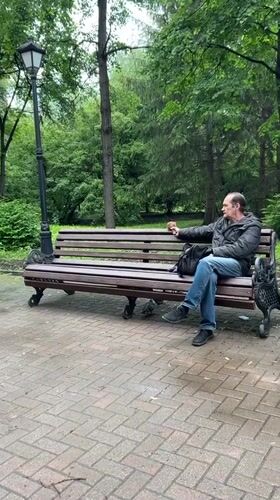 Man feeds squirrel in Yekaterinburg park while being filmed