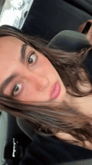 Woman makes animated faces at camera while in Mexico City car