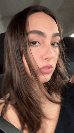 Woman makes animated faces at camera while in Mexico City car