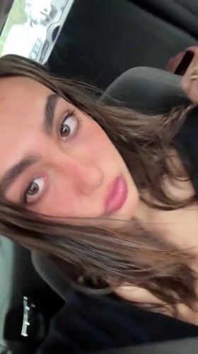 Woman makes animated faces at camera while in Mexico City car