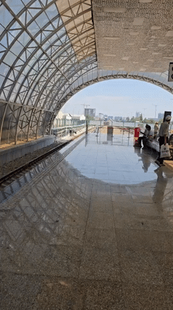 Empty Tashkent train platform under a curved transparent roof