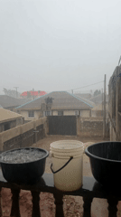 Rainy day scene with containers on residential railing
