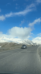 Vehicle travels mountain road near Gudauri, Georgia