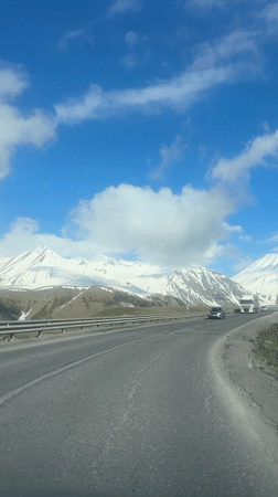 Vehicle travels mountain road near Gudauri, Georgia