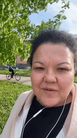 Woman films herself outdoors in park during early morning
