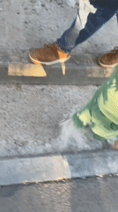 Father and child stroll through sunny Izhevsk streets