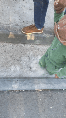 Father and child stroll through sunny Izhevsk streets
