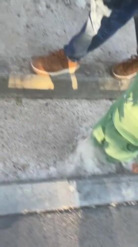 Father and child stroll through sunny Izhevsk streets