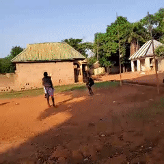 Children play soccer on dirt field in Akwanga, Nigeria