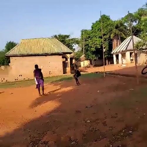 Children play soccer on dirt field in Akwanga, Nigeria
