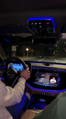 Car interior with blue ambient lighting filmed at night