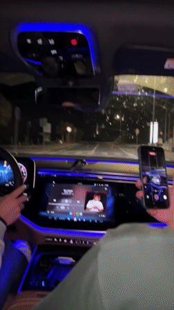 Car interior with blue ambient lighting filmed at night