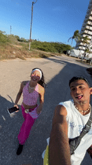 Young couple films selfies on Porlamar street