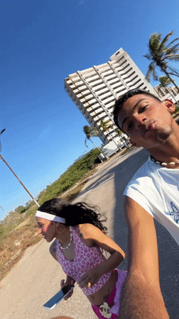 Young couple films selfies on Porlamar street