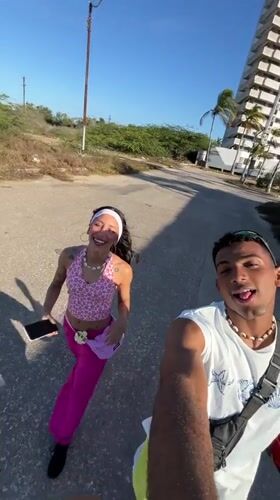 Young couple films selfies on Porlamar street