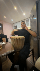 Men share informal djembe session in Septemvri kitchen
