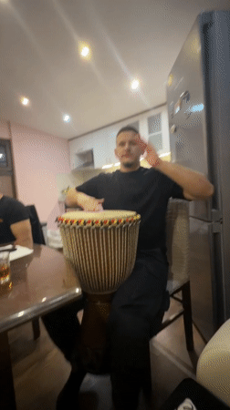 Men share informal djembe session in Septemvri kitchen