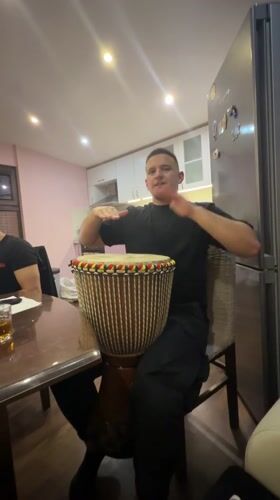 Men share informal djembe session in Septemvri kitchen