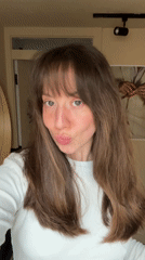 Woman takes selfies with coffee cup in London morning