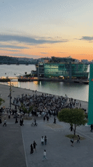 Evening crowds gather at Seoul waterfront during colorful sunset